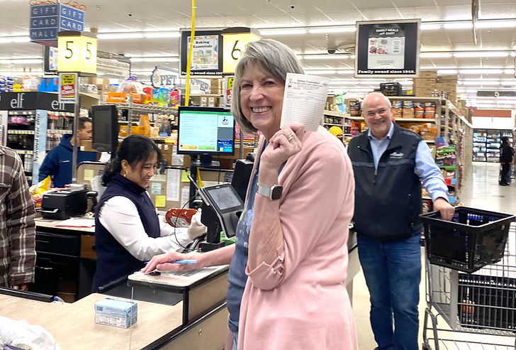 Mary Hames holds a charge slip at Seamart Quality Foods on Tuesday, April 28, 2026, as her husband, Roger, looks on. (Anna Laffrey / Daily Sitka Sentinel)